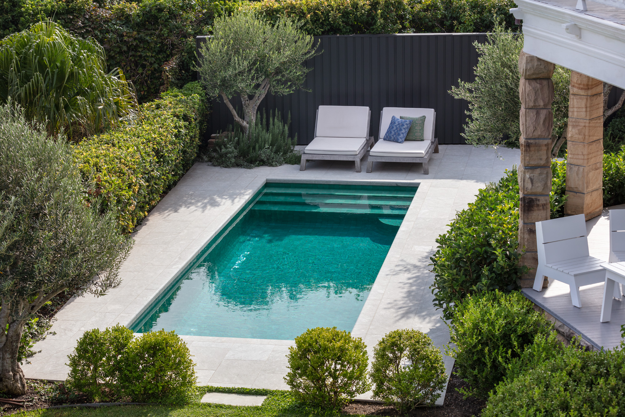 Rectangular pool with limestone coping is at home amongst architecture and environment.