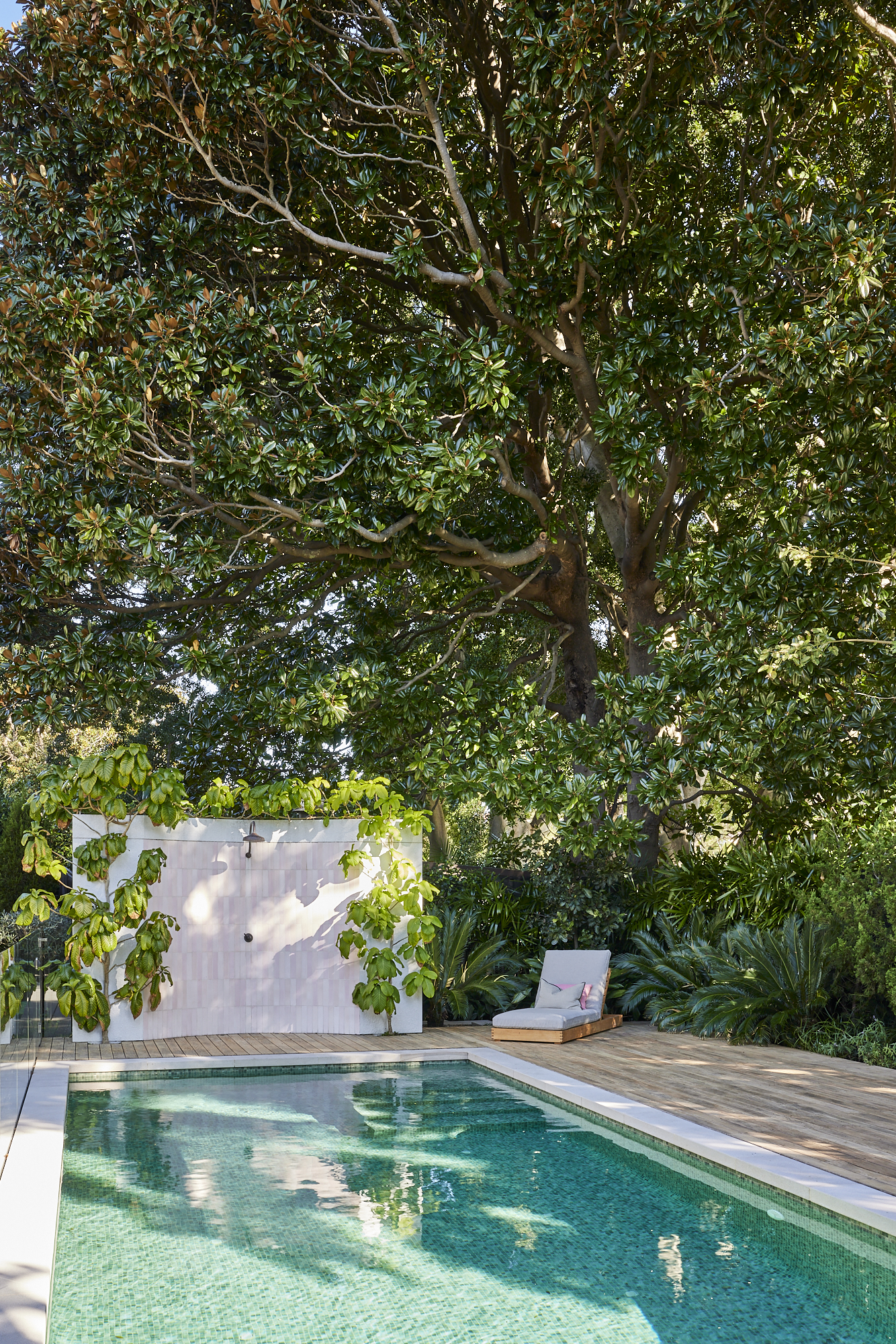 Beautiful Pink tiled outdoor Shower, framed by lush garden, accenting pool Photo by Wyer & Co. | Landscape Design in Rose Bay, New South Wales with @onsitesupplyanddesign.