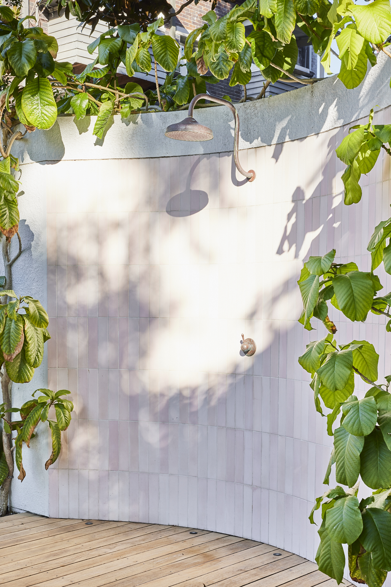 Beautiful Pink tiled outdoor Shower, framed by lush garden Photo by Wyer & Co. | Landscape Design in Rose Bay, New South Wales with @onsitesupplyanddesign.